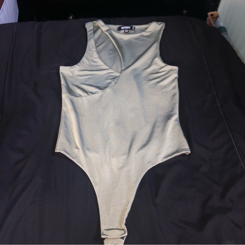 Asymmetric bodysuit with cut out slit in front. Pretty light green runs small.